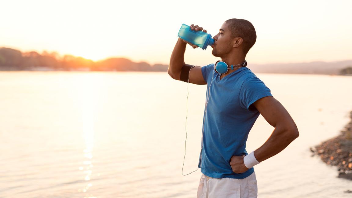 man drinking during workout